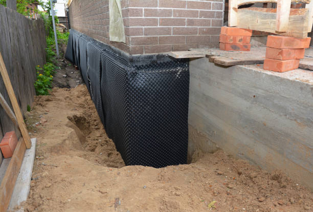 SJ Waterproofing Pros technician performing targeted Basement Waterproofing assessment in Coats, KS